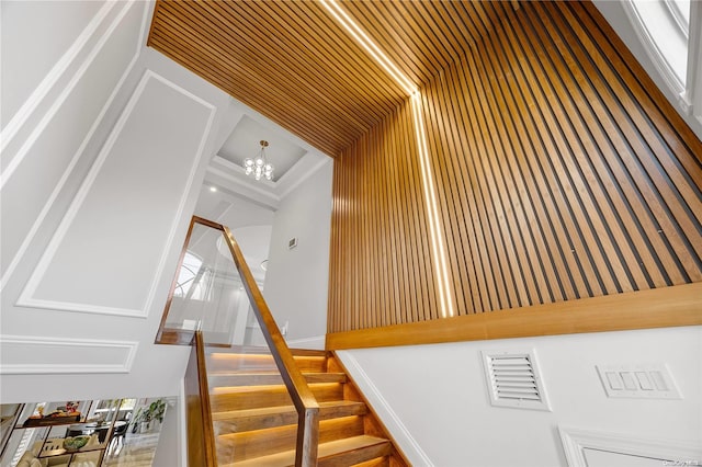 staircase with an inviting chandelier