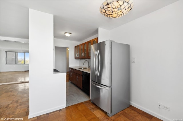 kitchen with stainless steel refrigerator, sink, light parquet floors, and black dishwasher