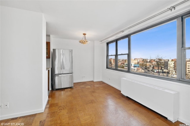 unfurnished dining area featuring radiator