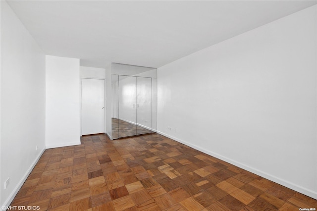 empty room featuring dark parquet floors