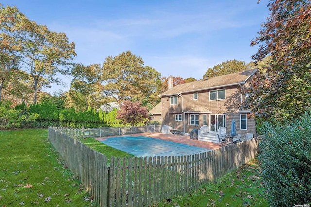 view of swimming pool featuring a lawn and a patio area