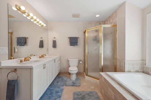 full bathroom with tile patterned floors, vanity, separate shower and tub, and toilet