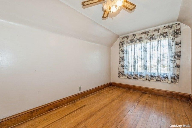 additional living space with hardwood / wood-style flooring, ceiling fan, and lofted ceiling