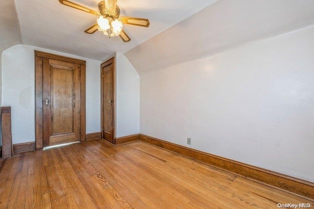 additional living space featuring ceiling fan, lofted ceiling, and light hardwood / wood-style flooring