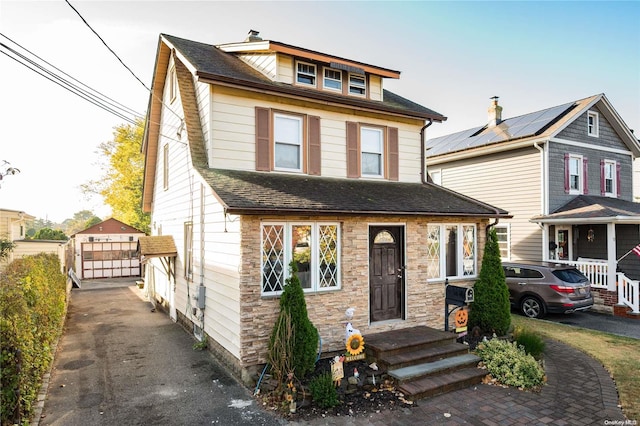 view of front facade with a garage and an outdoor structure