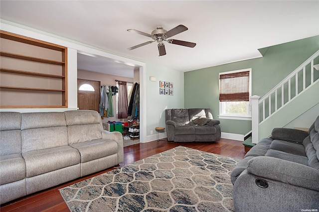 living room with dark hardwood / wood-style flooring and ceiling fan