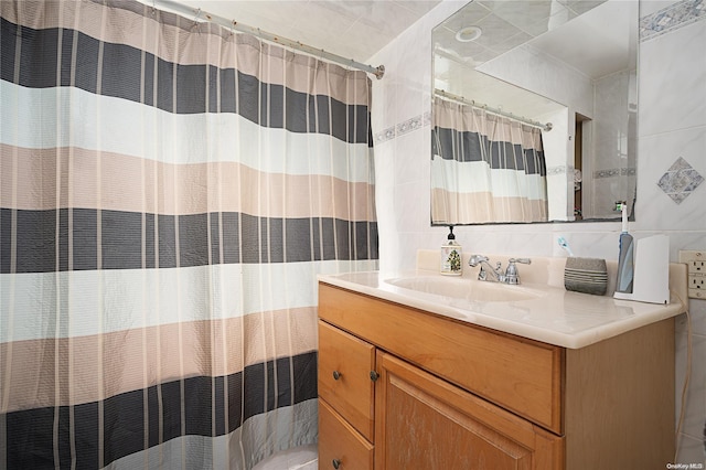 bathroom featuring backsplash, vanity, tile walls, and a shower with shower curtain