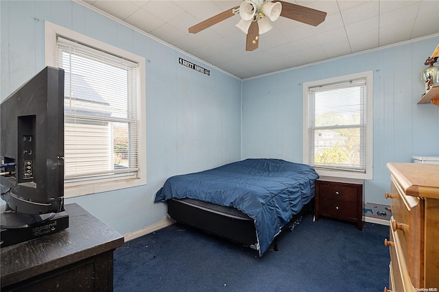 bedroom with dark carpet, ceiling fan, and ornamental molding