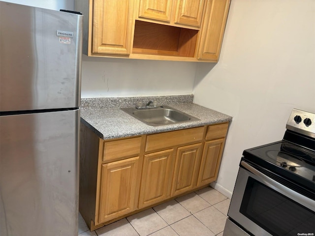 kitchen featuring light tile patterned flooring, stainless steel appliances, and sink