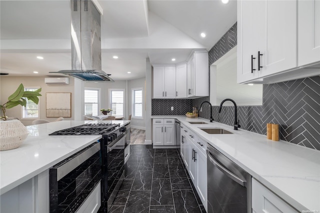 kitchen with a wall mounted air conditioner, appliances with stainless steel finishes, tasteful backsplash, white cabinetry, and island exhaust hood