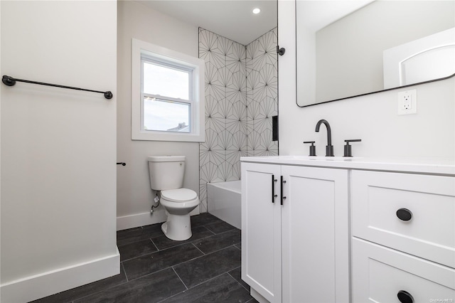 full bathroom with tile patterned floors, vanity, tiled shower / bath combo, and toilet