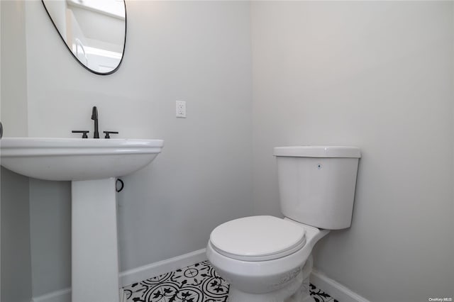 bathroom with tile patterned flooring, toilet, and sink