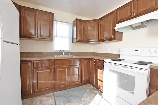 kitchen featuring sink, light tile patterned floors, and white appliances