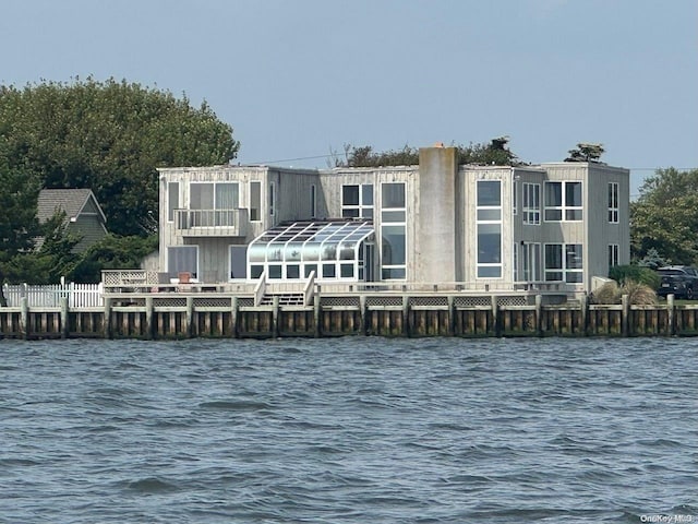 back of property with a water view