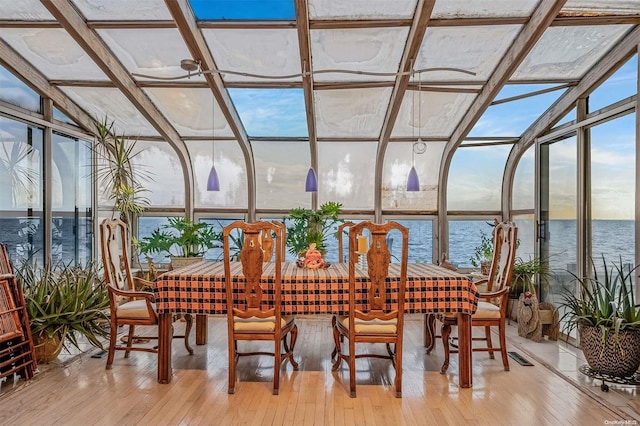 sunroom / solarium with a water view