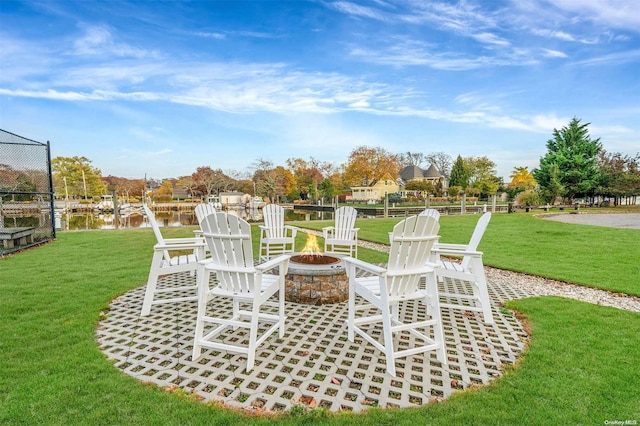 view of patio featuring a water view and a fire pit