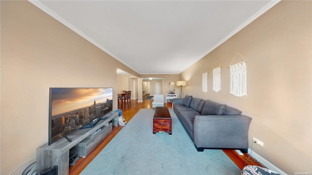 living room featuring hardwood / wood-style flooring and ornamental molding