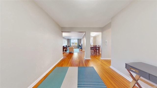 corridor with wood-type flooring