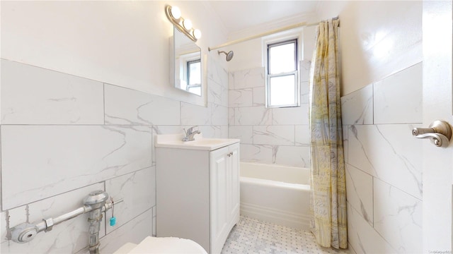 full bathroom featuring shower / bath combination with curtain, vanity, toilet, and tile walls