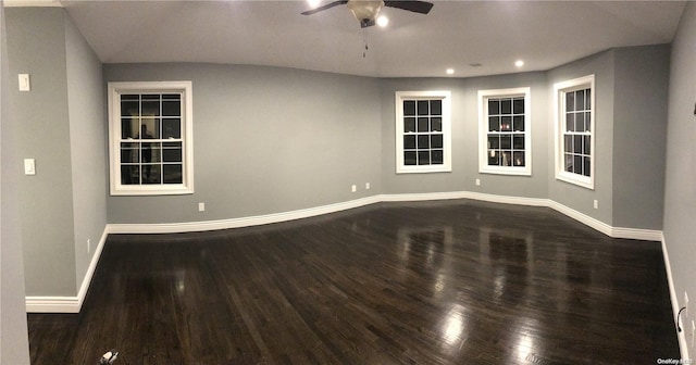 spare room featuring ceiling fan and dark hardwood / wood-style flooring