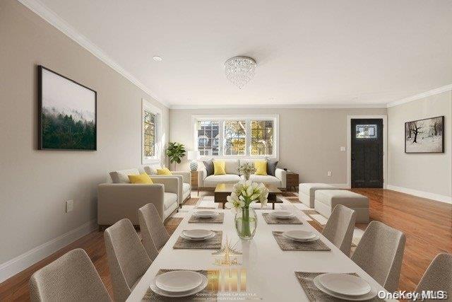 dining area featuring crown molding, hardwood / wood-style floors, and an inviting chandelier