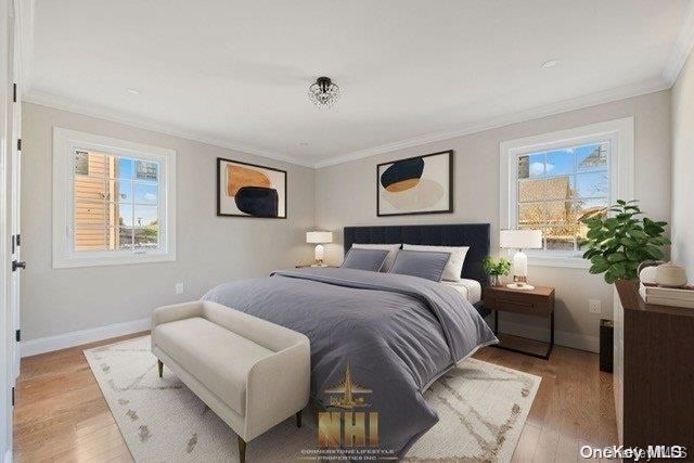 bedroom featuring crown molding and light hardwood / wood-style flooring