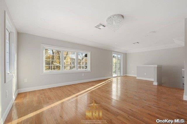 spare room with hardwood / wood-style floors