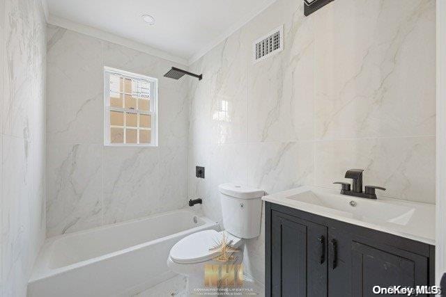 full bathroom featuring vanity, toilet, tile walls, and bathing tub / shower combination