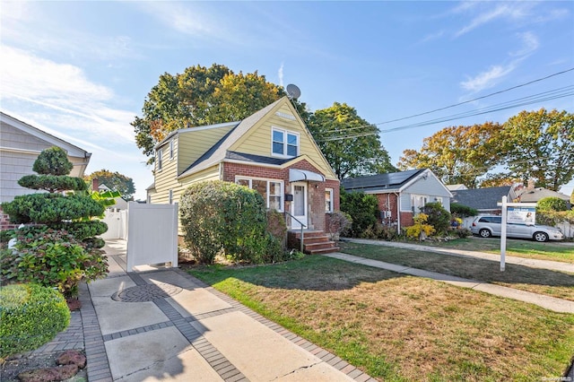 bungalow-style home with a front yard