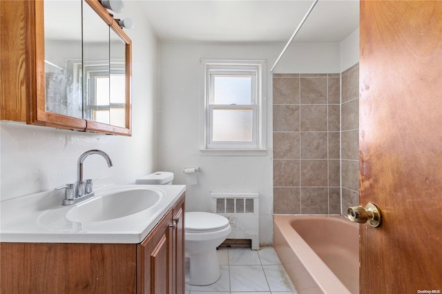 full bathroom featuring vanity, toilet, radiator, and tiled shower / bath combo