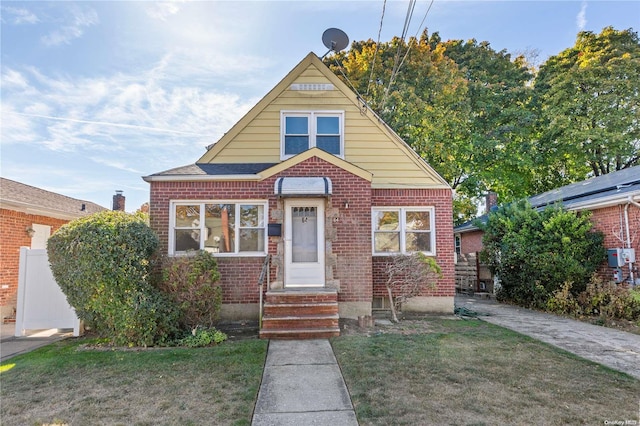 bungalow-style home with a front yard