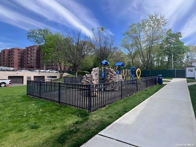 view of property's community with a playground and a lawn