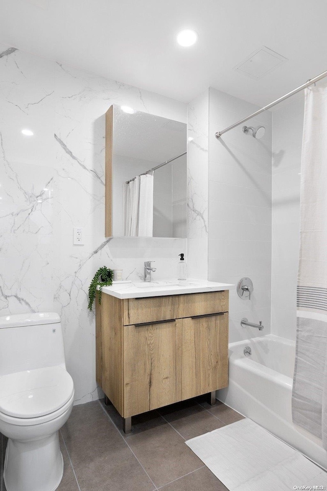 full bathroom featuring tile patterned flooring, vanity, toilet, and shower / tub combo