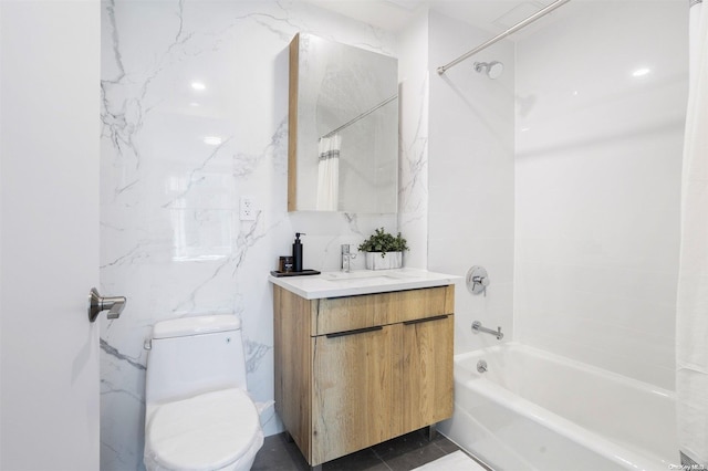 full bathroom featuring tiled shower / bath combo, toilet, and vanity