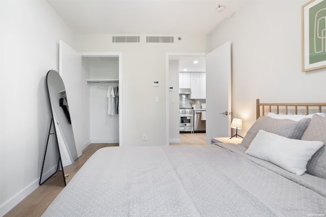 bedroom featuring light hardwood / wood-style flooring and a closet