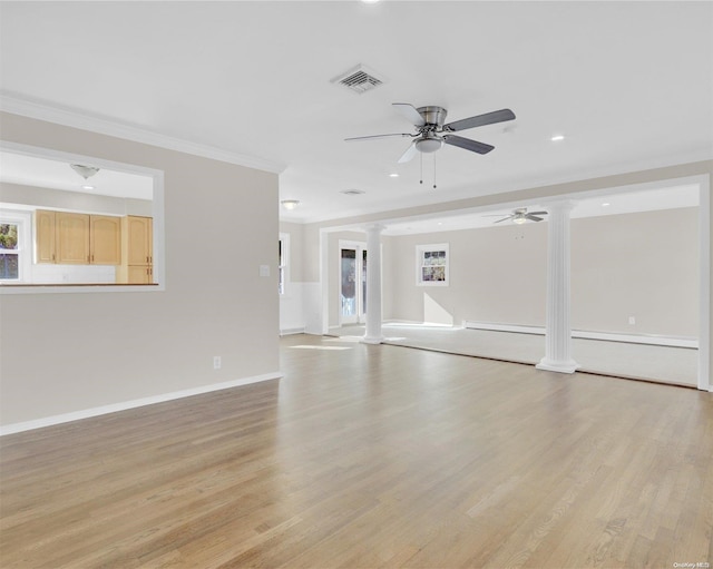 unfurnished living room featuring ceiling fan, light hardwood / wood-style floors, ornamental molding, and ornate columns