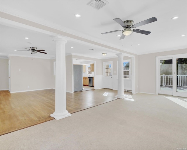 unfurnished living room featuring ceiling fan, decorative columns, ornamental molding, and light hardwood / wood-style flooring