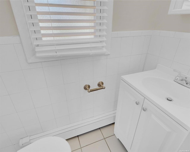 bathroom with vanity and tile walls