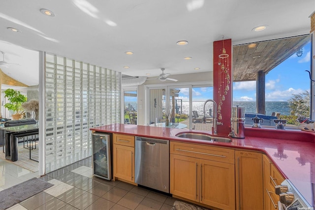 kitchen with sink, beverage cooler, stainless steel dishwasher, tile patterned floors, and a water view