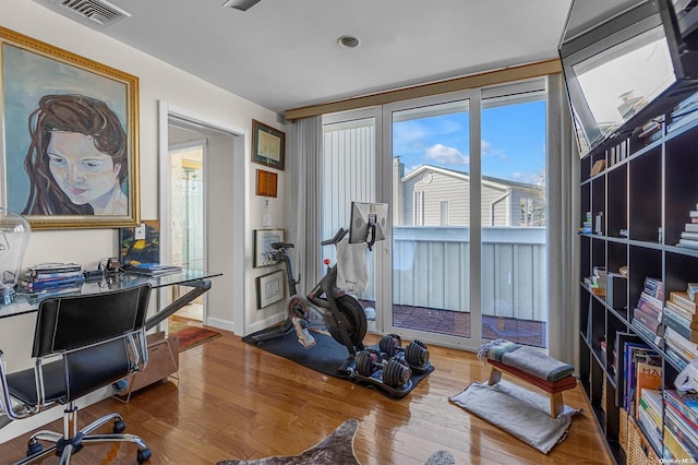 exercise room with hardwood / wood-style floors