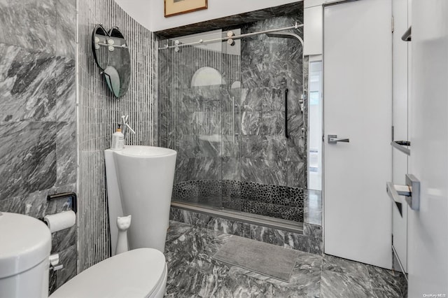 bathroom with tile walls, an enclosed shower, and toilet