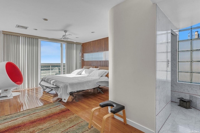 bedroom featuring ceiling fan and light hardwood / wood-style floors