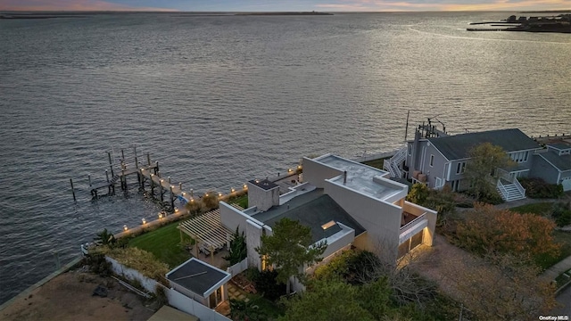 aerial view at dusk with a water view