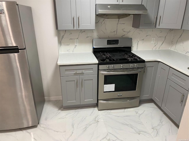 kitchen with gray cabinetry, stainless steel appliances, and range hood