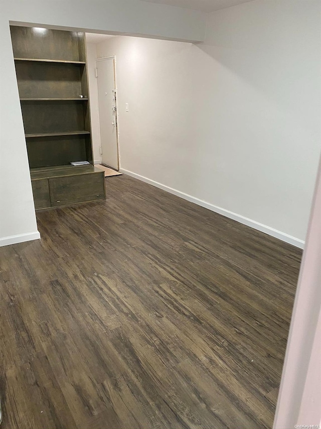 unfurnished living room featuring dark wood-type flooring