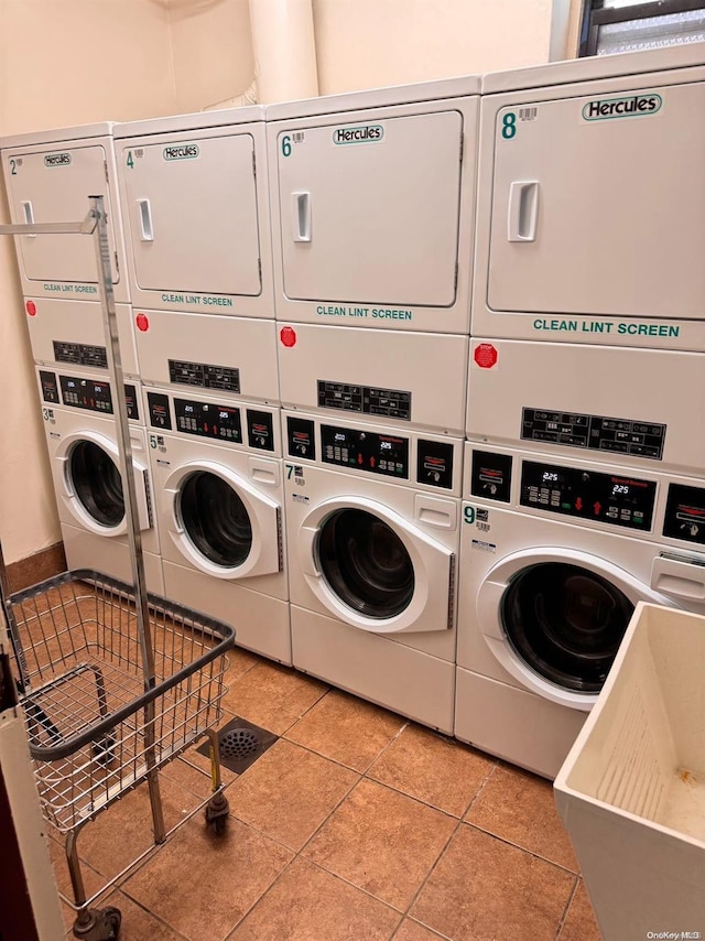 laundry room featuring light tile patterned floors, washing machine and dryer, and stacked washer and dryer