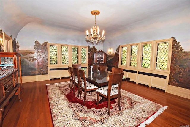 dining area with lofted ceiling, a healthy amount of sunlight, dark hardwood / wood-style floors, and a notable chandelier