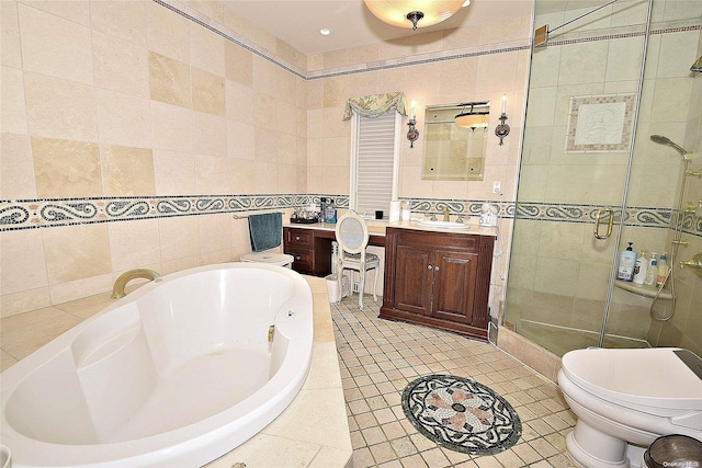 full bathroom featuring toilet, vanity, separate shower and tub, and tile walls