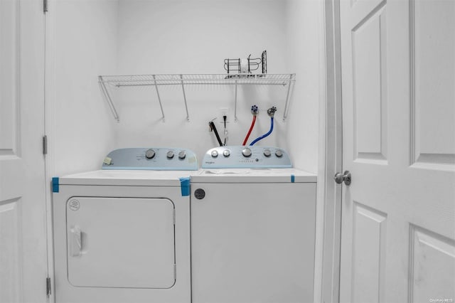 clothes washing area featuring separate washer and dryer