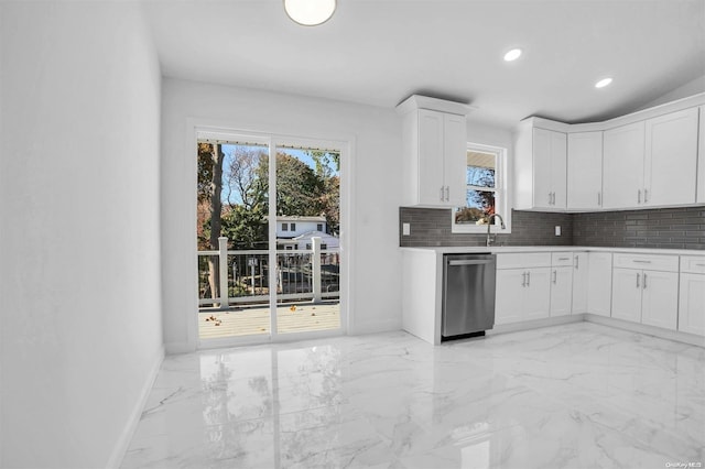 kitchen with white cabinets, tasteful backsplash, dishwasher, and sink